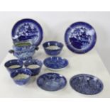 Group of blue Historical Staffordshire cups and saucers and slipware dish, one piece with American