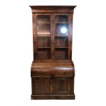C19th Flame Mahogany Cylinder Bureau/Bookcase on plinth base with pair doors, pull-out slide, fitted