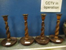 SET OF FOUR OAK FRAMED BARLEY TWIST COLUMN CANDLESTICKS