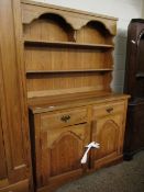 PINE DRESSER WITH TWO FIXED SHELVES, THE BASE WITH TWO DRAWERS OVER TWO ARCHED PANELLED CUPBOARD