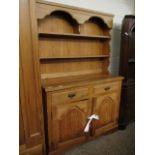 PINE DRESSER WITH TWO FIXED SHELVES, THE BASE WITH TWO DRAWERS OVER TWO ARCHED PANELLED CUPBOARD