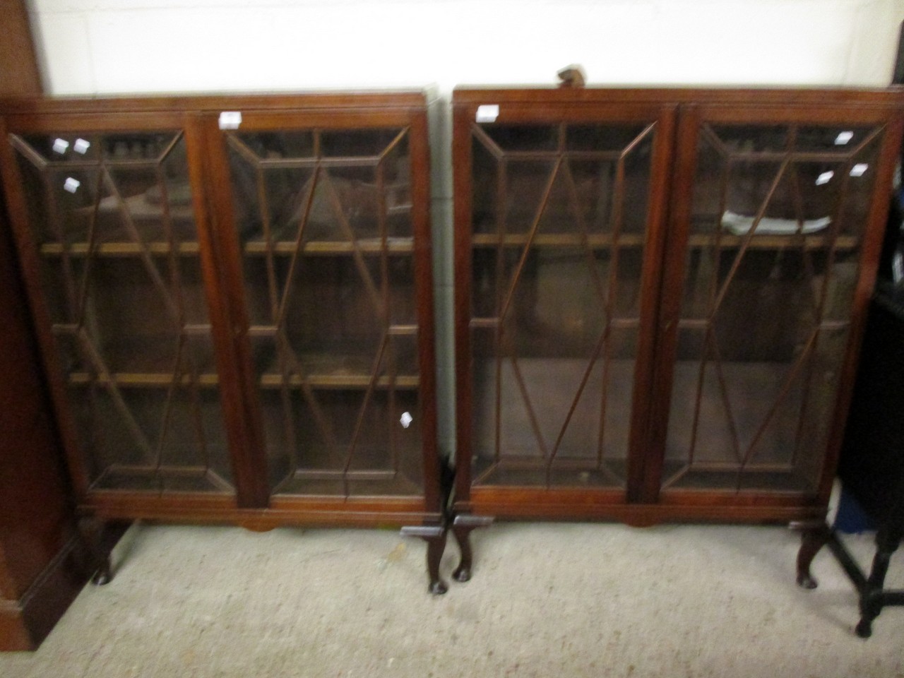 PAIR OF MAHOGANY BOOKCASES WITH TWO ASTRAGAL GLAZED DOORS RAISED ON PAD FEET