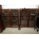 PAIR OF MAHOGANY BOOKCASES WITH TWO ASTRAGAL GLAZED DOORS RAISED ON PAD FEET