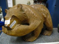 BLACK FOREST TYPE CARVED MODEL OF A BEAR WITH A FISH IN ITS MOUTH