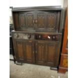 MID-20TH CENTURY LINENFOLD FRONT COURT CUPBOARD WITH TWO DOORS OVER TWO DRAWERS AND TWO LINENFOLD