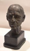 Bronze effect plaster bust of a gentleman on an ebonised stand^ 44cm high