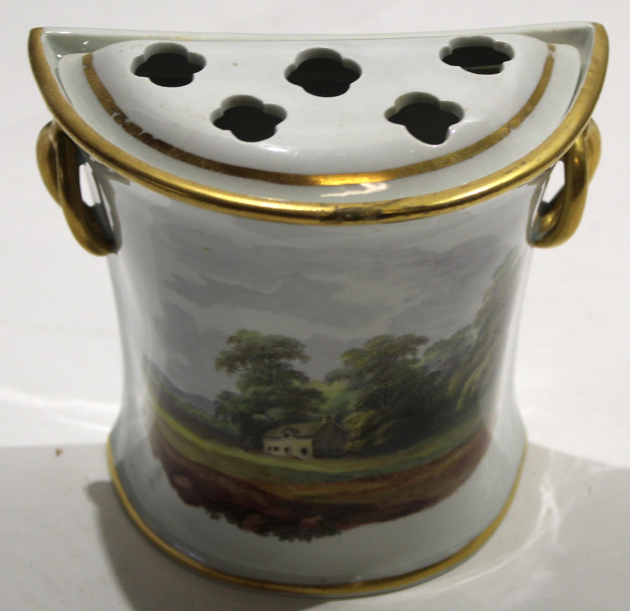 Early 19th century Davenport bough pot^ the front decorated with a landscape design^ the base with