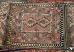 Kelim rug with hanging tassels^ typical geometric decoration^ mainly puce field^ 1.07 x .9m