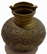 Oriental brass vase and cover with a scrolling design