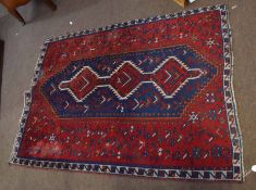 Caucasian style carpet^ mainly red and blue field with central geometric panel^ double gull