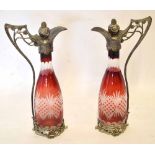 Pair of WMF style plated claret jugs with Bohemian glass bodies^ the handles and bases moulded