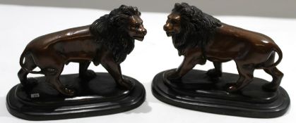 Pair of bronze coloured metal figures of lions^ 17cm high