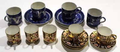 Collection of five Royal Crown Derby coffee cans and saucers decorated in typical fashion with an