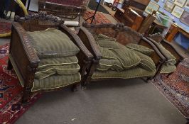 Victorian oak Bergere suite in the Gothic manner^ comprising a two-seater sofa and two matching easy