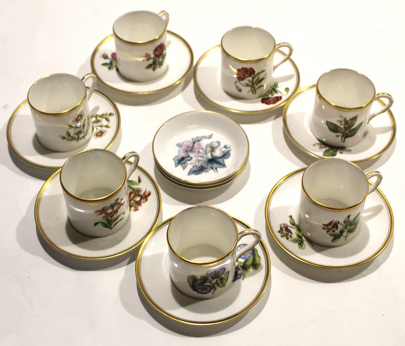 Collection of Royal Worcester coffee cans and saucers^ all painted with floral subjects^ together