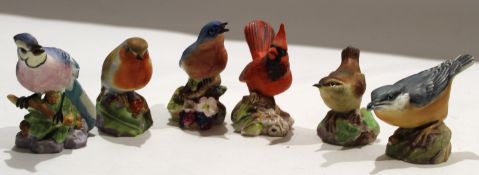 Group of six Royal Worcester birds on floral bases^ including Blue Tit and a Robin^ and a blue bird^