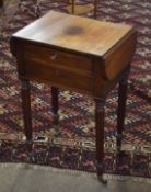 19th century mahogany work table with two frieze drawers flanked by drop flaps raised on reeded