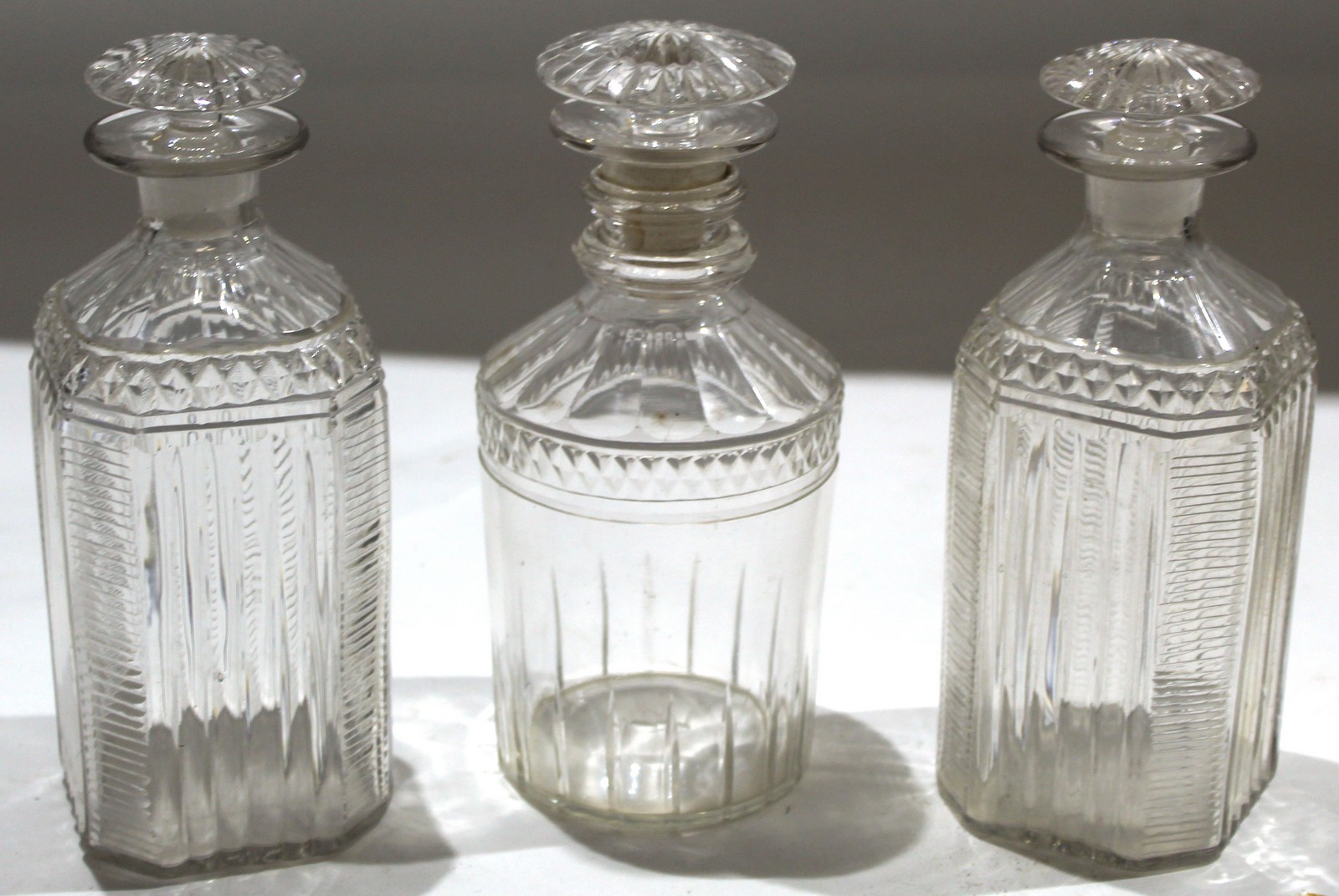Group of late 19th century glass decanters with pillar style decoration and mushroom knops^ (3)
