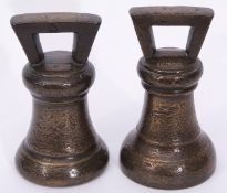 Two early 19th century bronze bell shaped 14lb weights^ each 19cm high