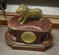 Marbled mantel clock (a/f) applied with gilt metal lion mount over a circular face with Roman