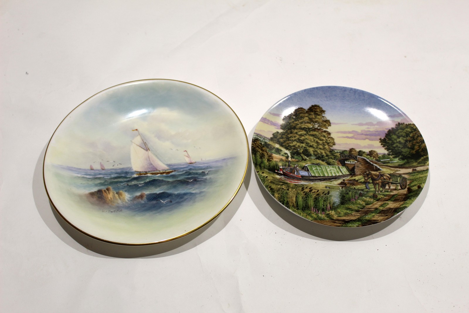 Royal Worcester plate decorated with sailing ships^ signed R Rushton^ factory puce mark to base^