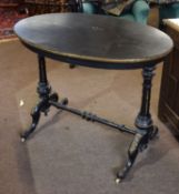 19th century ebonised and gilt metal mounted oval occasional table^ two supports joined by a similar
