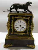 Bronze or spelter gilt metal mantel clock crested with a figure of a rampant lion over a circular