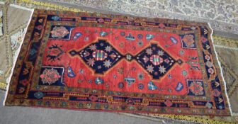 Modern Caucasian carpet^ central panel of linked lozenges on a mainly red field within triple gull