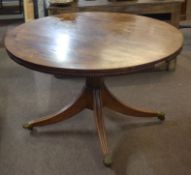 Regency period mahogany circular breakfast table^ cross banded top raised on a plain column