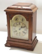 Early 20th century oak cased bracket clock^ arched silvered face with Roman chapter ring^ separate