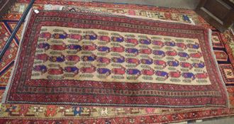 Caucasian carpet^ central panel of geometric designs^ beige and puce field^ .92 x 1.7m