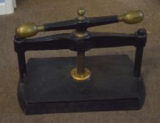 Black painted and cast metal book press with brass mounts^ 57cm wide