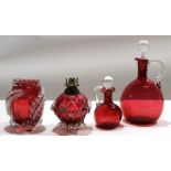 Group of cranberry glass wares including two decanters with stoppers^ further small cranberry oil