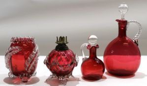 Group of cranberry glass wares including two decanters with stoppers^ further small cranberry oil