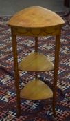 Edwardian satinwood three-tier work table^ upper tier with lifting lid enclosing compartments^ two