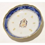 18th century Chinese export armorial dish with armorial to centre within blue shaped borders^ 21cm