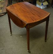 Mahogany Pembroke table^ drop flaps over tapering supports^ brass caps and casters^ 83cm wide