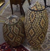 Two modern |Ali Baba| type lidded wickerwork containers^ 95cm and 70cm high respectively