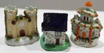 English Pottery wares to include a Staffordshire cottage^ a house and a Staffordshire cottage (3)