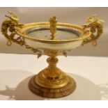 Gilt metal tazza or centrepiece mounted on an onyx base, the bowl flanked with dragon handles,