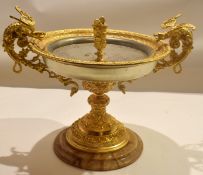 Gilt metal tazza or centrepiece mounted on an onyx base, the bowl flanked with dragon handles,