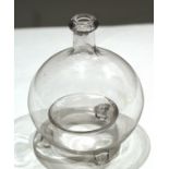 Globular glass vase raised on three stub feet^ 20cm high