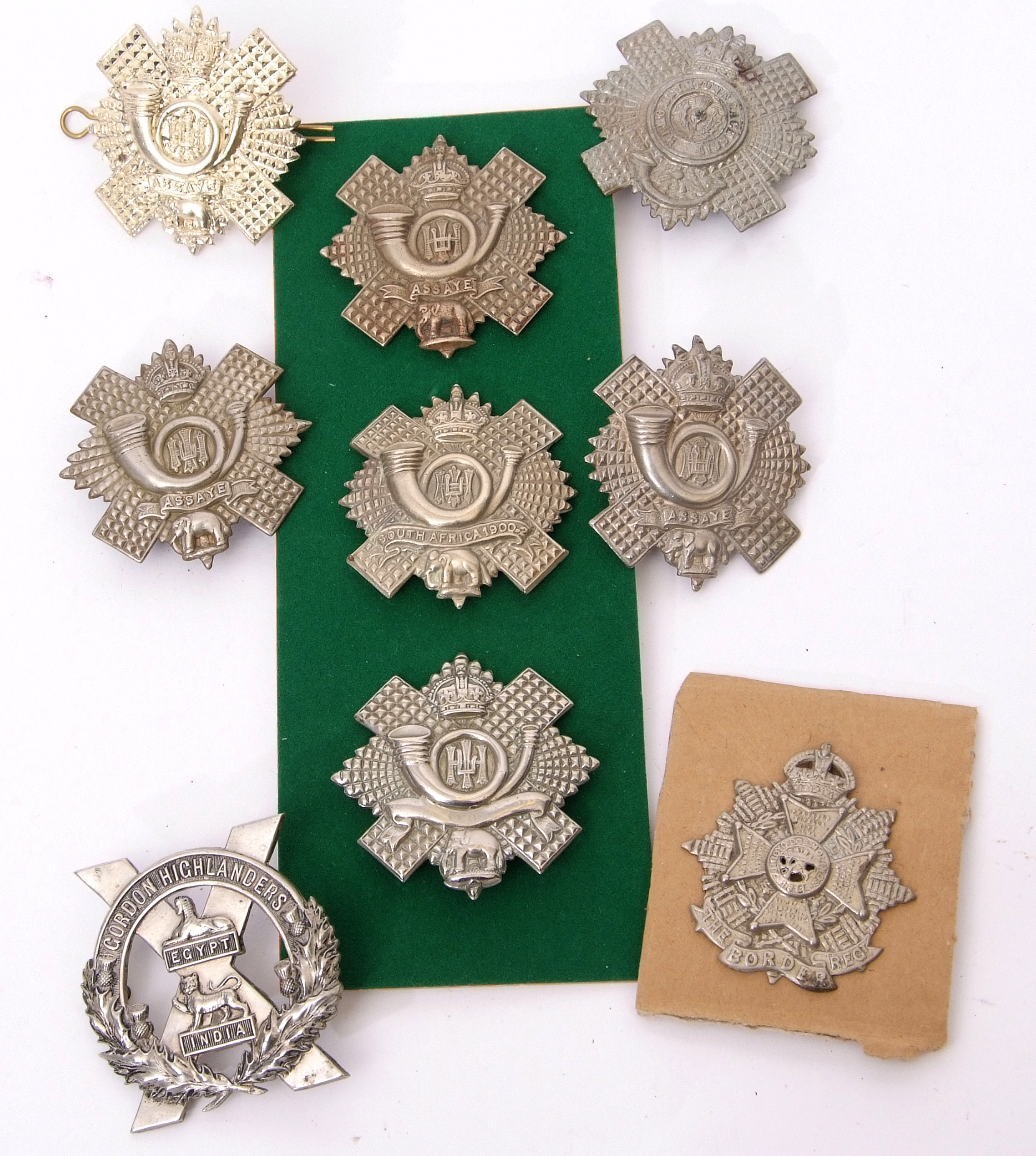 Mixed Lot: nine Scottish Glengarry and feather bonnet cap badges to include Gordon Highlanders,