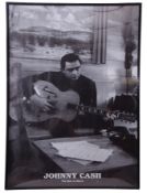 Framed poster of Johnny Cash. Note: sold on behalf of a local charity