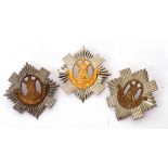 Group of three Royal Scots cap badges (3)