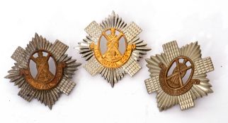 Group of three Royal Scots cap badges (3)