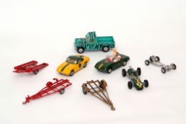 Group of Corgi Lotus racing vehicles with trailers, and a further Land Rover Safari example