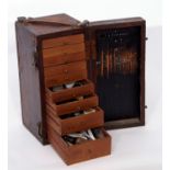 Wooden box containing a selection of watchmaker's tools in original case, with leather strap, the