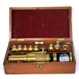 Boxed brass microscope with accessories