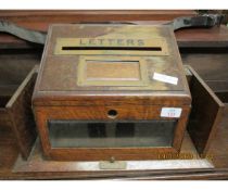 OAK FRAMED LETTER RACK WITH GLAZED DOOR AND SIDE COMPARTMENTS AND BRASS MOUNTS